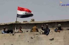 الجيش والحشد الشعبي يرفعون العلم العراقي فوق مبنى جامعة ا?نبار بعد تحريرها بالكامل